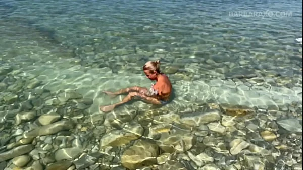 Slender tanned blonde gets fucked on the beach by the sound of waves during a photo shoot